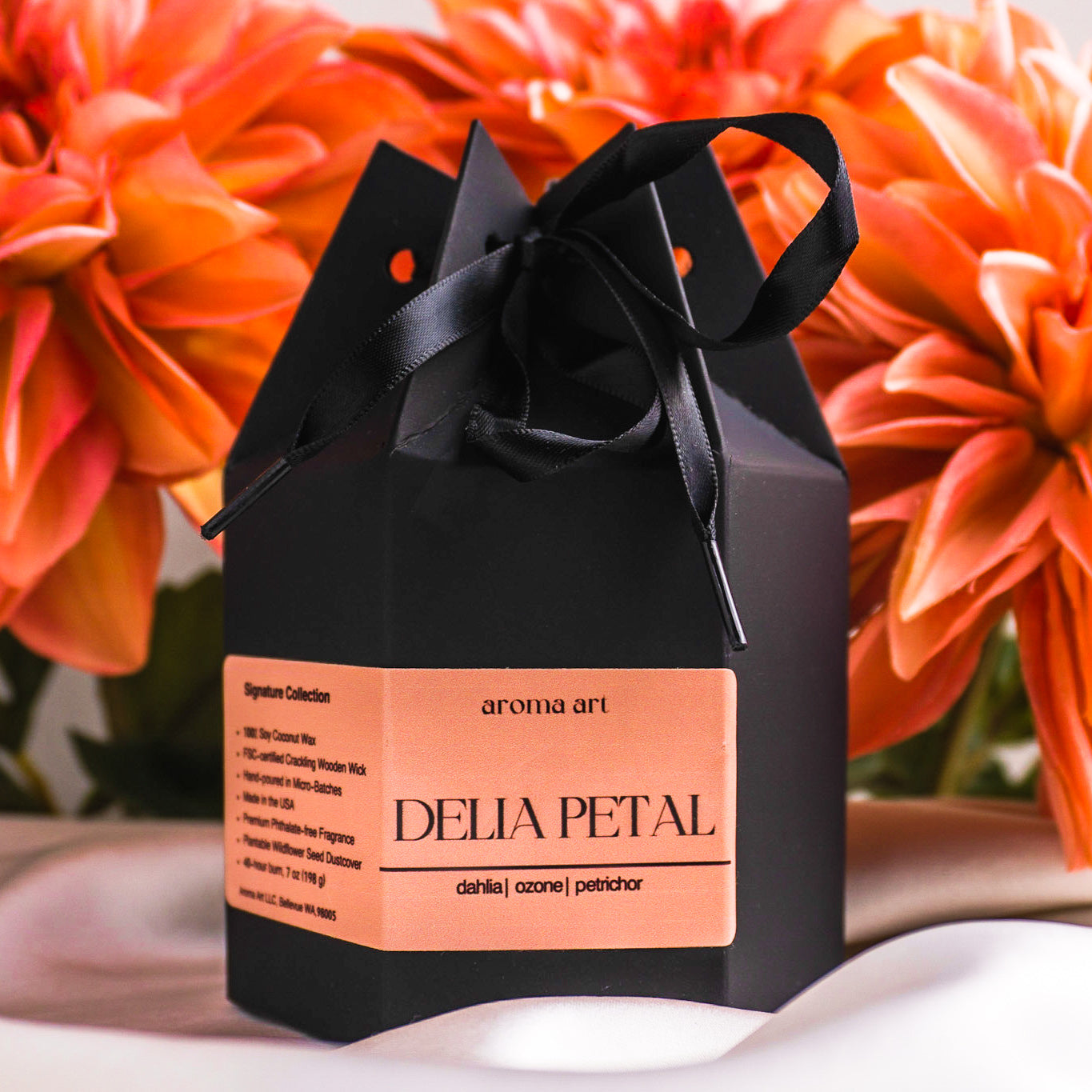 A 7oz luxurious soy-coconut wax crackling wooden wick fall candle called Delia Petal that will fill your home with the earthy, atmospheric, and refreshing scent of bitter dahlia, ozone, and petrichor. Perfect for a night of relaxation or a cozy fall evening. Shown in its luxe black gift box, perfect for gifting.
